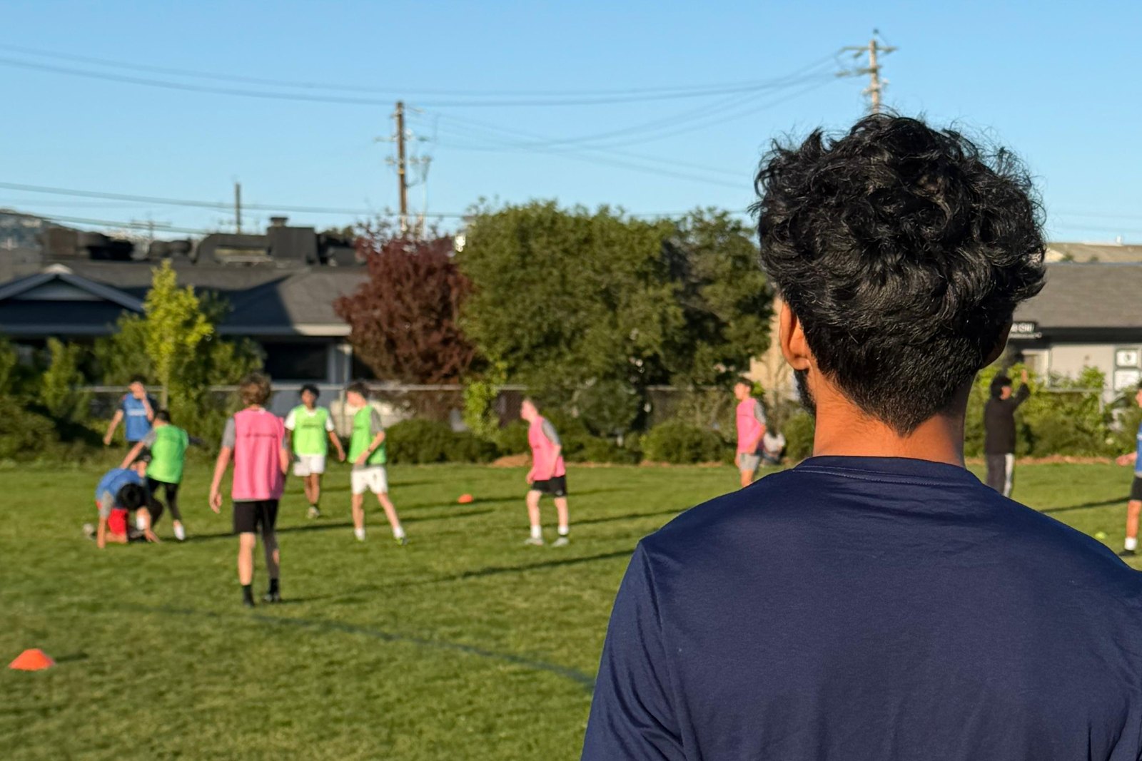 Coach Jay (Saad Jabroun) overseeing a youth soccer training session